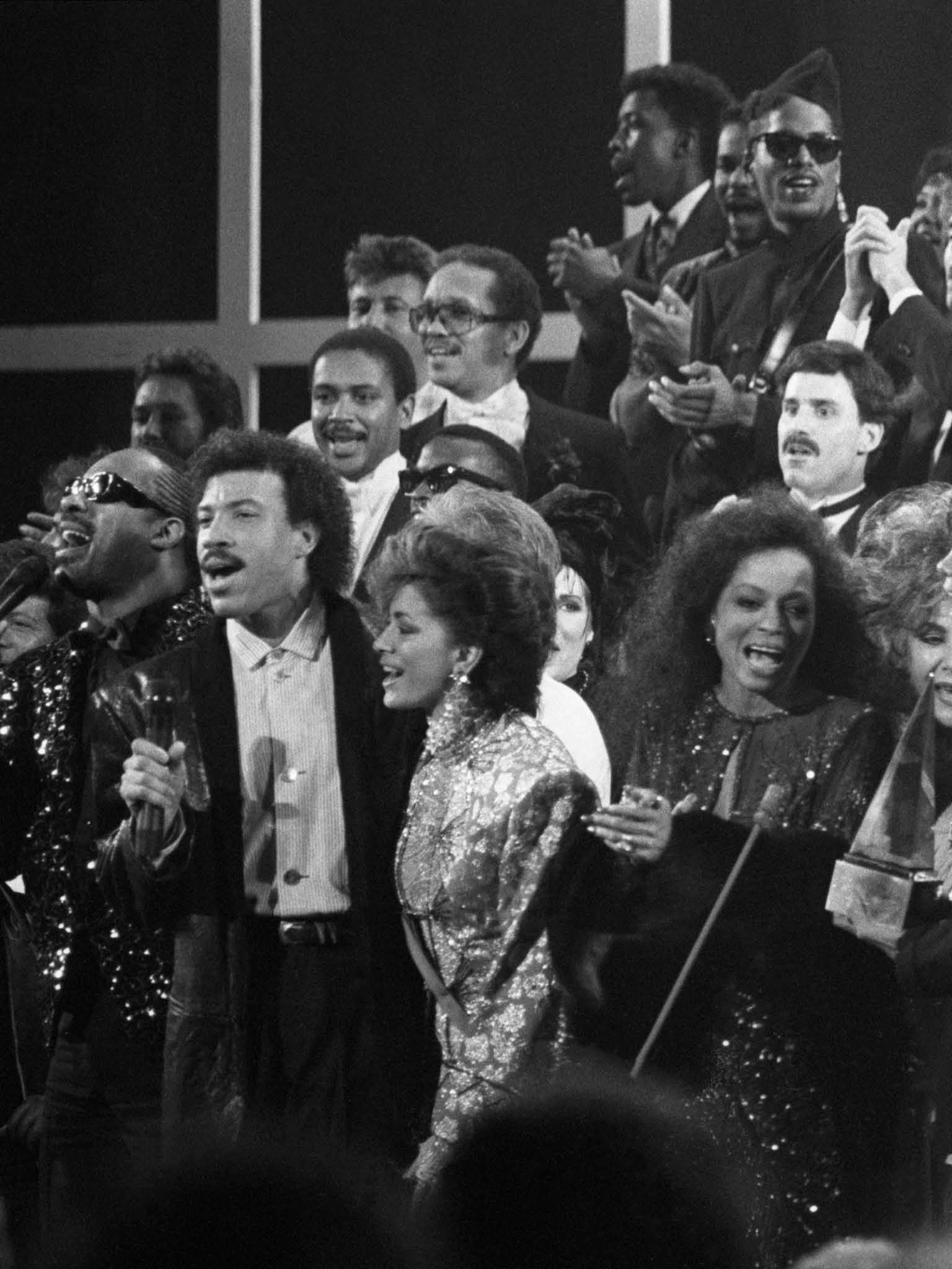 A variety of music and movie stars sing "We Are The World" a song written to benefit famine victims in Ethiopia. Across the front row stands: Stevie Wonder, Lionel Richie, Sheila E., Diana Ross, Elizabeth Taylor, Michael Jackson, Smokey Robinson, Kim Carnes, Michael Douglas, and Janet Jackson., Image: 15371183, License: Rights-managed, Restrictions: , Model Release: no, Credit line: Profimedia, Corbis